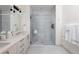 Elegant bathroom with double vanity, large shower, and marble tile at 1750 Wewatta St # 1940, Denver, CO 80202