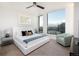 Spacious bedroom with city views and a sitting area at 1750 Wewatta St # 1940, Denver, CO 80202