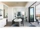 Open concept dining area with white table and gray chairs, view to balcony and city at 1750 Wewatta St # 1940, Denver, CO 80202