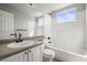 Well-lit bathroom with white tiled walls, vanity, and a bathtub/shower combo at 5934 Kingsfield St, Castle Rock, CO 80104