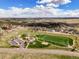 Aerial shot of community park featuring playground, sports field, walking path, and parking, designed for community recreation at 5934 Kingsfield St, Castle Rock, CO 80104