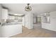 Bright kitchen featuring white cabinets, granite countertops, and modern lighting fixtures at 5934 Kingsfield St, Castle Rock, CO 80104