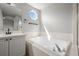 Bright bathroom with a white soaking tub under an octagonal window at 5934 Kingsfield St, Castle Rock, CO 80104