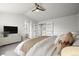 Spacious main bedroom featuring a ceiling fan, plush carpet, and ensuite bathroom access at 5934 Kingsfield St, Castle Rock, CO 80104