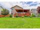 Spacious backyard with a wooden pergola, lush lawn, and mature landscaping at 9537 Chesapeake St, Highlands Ranch, CO 80126