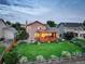 Well-maintained backyard featuring a spacious deck, lush lawn, and manicured landscaping at 9537 Chesapeake St, Highlands Ranch, CO 80126
