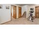 Basement space with exercise equipment and carpeted floor, adjacent to multiple closets and stairs at 9537 Chesapeake St, Highlands Ranch, CO 80126