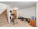 Basement space with exercise equipment, carpeted floor and stairway to upper level at 9537 Chesapeake St, Highlands Ranch, CO 80126