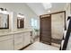 Light and airy bathroom features double sinks, a skylight, and a modern walk-in shower with a bench at 9537 Chesapeake St, Highlands Ranch, CO 80126