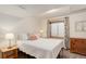 Cozy bedroom with natural light, a side table, and a dresser for ample storage space at 9537 Chesapeake St, Highlands Ranch, CO 80126