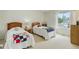 Bright bedroom features two twin beds, a large window and light colored carpet at 9537 Chesapeake St, Highlands Ranch, CO 80126