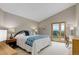 Bright bedroom features vaulted ceilings, a private balcony, and neutral tones for a relaxing retreat at 9537 Chesapeake St, Highlands Ranch, CO 80126