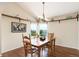 Inviting dining room with a wooden table, hardwood floors, and ample natural light from large windows at 9537 Chesapeake St, Highlands Ranch, CO 80126