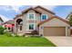 Charming two-story home boasts a brick facade, well-manicured lawn, and an attached two-car garage at 9537 Chesapeake St, Highlands Ranch, CO 80126