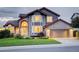 Charming two-story home with a brick and siding exterior, well-manicured lawn, and attached garage at 9537 Chesapeake St, Highlands Ranch, CO 80126