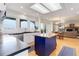 Well-lit kitchen featuring white cabinetry, a center island, and views into the dining and living areas at 9537 Chesapeake St, Highlands Ranch, CO 80126