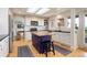 Bright kitchen boasts white cabinets, an island with seating, and a seamless flow into the adjacent rooms at 9537 Chesapeake St, Highlands Ranch, CO 80126