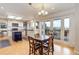 Bright eat-in kitchen featuring white cabinetry, stainless appliances, and access to a covered patio with view at 9537 Chesapeake St, Highlands Ranch, CO 80126