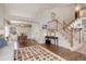 Open-concept living room with hardwood floors, a staircase with wooden railing, and a dining area at 9537 Chesapeake St, Highlands Ranch, CO 80126