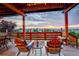 Relaxing outdoor patio with chairs and a table, perfect for enjoying the scenic views and sunset at 9537 Chesapeake St, Highlands Ranch, CO 80126