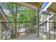 This relaxing balcony boasts a metal guard rail with views of mature trees and a green landscape at 980 S Dahlia St # F, Denver, CO 80246