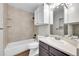 Bathroom features tile walls, and a tub/shower combination and classic vanity area at 980 S Dahlia St # F, Denver, CO 80246