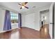 Bedroom features hardwood floors, double-door closet, and window with neighborhood views at 980 S Dahlia St # F, Denver, CO 80246