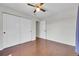 This bedroom is complete with hardwood floors, a ceiling fan, and double-door closet at 980 S Dahlia St # F, Denver, CO 80246