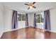 Light-filled bedroom with hardwood floors, two windows, and neutral walls create a relaxing retreat at 980 S Dahlia St # F, Denver, CO 80246