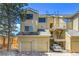 This exterior showcases multiple units with a two-car garage, private balconies, and maintained landscaping at 980 S Dahlia St # F, Denver, CO 80246