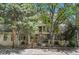 Beautiful condo exterior with a well-maintained lawn, mature trees, and gated entry for security at 980 S Dahlia St # F, Denver, CO 80246