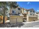 This exterior showcases multiple units with a two-car garage, private balconies, and maintained landscaping at 980 S Dahlia St # F, Denver, CO 80246