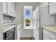 Kitchen featuring white appliances, tile floors and natural light from a window at 980 S Dahlia St # F, Denver, CO 80246