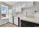 Compact kitchen with white appliances, tile floors, and natural light at 980 S Dahlia St # F, Denver, CO 80246