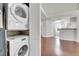 Modern laundry room with stacked washer and dryer in an open living space at 980 S Dahlia St # F, Denver, CO 80246