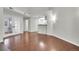 Open living room area leading to a kitchen with hardwood flooring and lots of light at 980 S Dahlia St # F, Denver, CO 80246