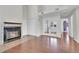 Living room with fireplace, hardwood floors, closet doors, and double glass doors at 980 S Dahlia St # F, Denver, CO 80246