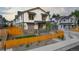 Modern townhome featuring a fenced yard, landscaped front, and stylish architectural details at 4008 Upham St, Wheat Ridge, CO 80033