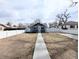 Fully fenced backyard with sidewalk and modern landscaping, offers space for outdoor living at 1164 Wabash St, Denver, CO 80220