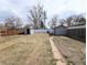 Generous backyard with two storage sheds and updated fencing offers ample space and privacy at 1164 Wabash St, Denver, CO 80220
