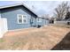 A view of the backyard, showing the exterior of the house with access to utilities at 1164 Wabash St, Denver, CO 80220