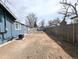 Large, blank canvas backyard with wood fence and detached garage/shed presents exciting possibilities at 1164 Wabash St, Denver, CO 80220