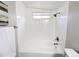 Bright white bathroom shower and tub combination with a window to let in natural light at 1164 Wabash St, Denver, CO 80220