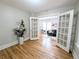 Bedroom featuring wood floors and glass paneled doors leading to living room at 1164 Wabash St, Denver, CO 80220