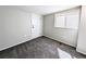 Cozy bedroom with neutral colored carpet, white walls, and a large window for natural light at 1164 Wabash St, Denver, CO 80220