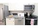 A close up of kitchen featuring stainless appliances and granite countertops at 1164 Wabash St, Denver, CO 80220