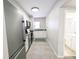 Galley kitchen featuring white cabinets, granite countertops, and stainless steel appliances at 1164 Wabash St, Denver, CO 80220