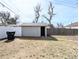 Spacious backyard shed offering potential for workshop or storage, alongside privacy fencing at 1164 Wabash St, Denver, CO 80220
