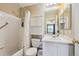 Well-lit bathroom features a shower/tub combo and vanity with sink at 5786 Biscay St, Denver, CO 80249