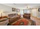 Cozy living room featuring hardwood floors, a ceiling fan, and comfortable seating area at 5786 Biscay St, Denver, CO 80249